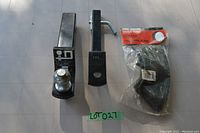 Photo showing two trailer hitch receivers side-by-side with an inner tube in packaging