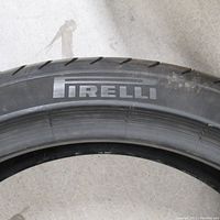Sidewall of the tire showing the Pirelli brand name imprinted in raised letters.
