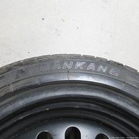 Close-up photo showing Nankang brand and tire size 235/45/17 on the tire sidewall.