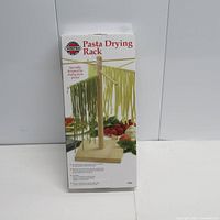 Front packaging image showing pasta drying rack with pasta hanging.