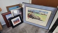 Full lot overview showing six framed pieces including the Mercedes poster, nature art, and mirror