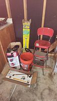 Various garden tools and accessories including boxes, bucket, and chair, showing general lot content