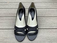 Top-down photo showing the black open-toed woven strap design and label inside the shoes.