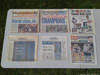Six newspapers laid out on a table showing front page headlines related to 1992 Toronto sports milestones including Blue Jays World Series and Maple Leafs games