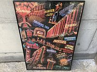Framed 1000-piece puzzle featuring neon casino signs from Las Vegas casinos, showing multiple iconic casino signs and the overall look of the puzzle and frame.