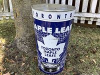 Front view of the blue metal trash bin with Toronto Maple Leafs logo and NHL Stanley Cup image, showing the text TORONTO around the top edge.