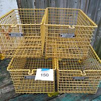 Photo showing all four yellow coated wire locker baskets stacked in two rows, with visible metal label plates on front of each basket.