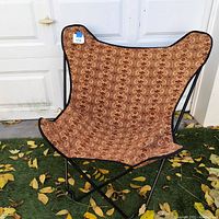 Front view of butterfly chair with patterned cover on frame, showing black metal frame and fabric design.
