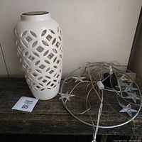 Side view of white ceramic solar light and IKEA star light mobile with wiring on wooden surface