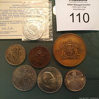 Photo showing assortment of commemorative and other coins including Churchill, 1939 Royal Visit, Queen Elizabeth II Coronation and Silver Jubilee, 1944 half crown, Elizabeth and Prince Philip silver anniversary coin, and Ontario silver jubilee token (plastic).