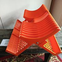 Three quarter side view showing the curved slots for dishes, folding hinge, and front edge damage.