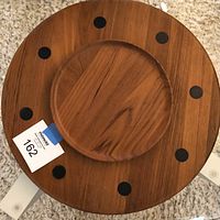 Top view of the circular teak lazy susan tray showing the black inserts and rotating middle section.
