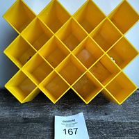 Front view of the yellow honeycomb spice rack showing 15 interconnected hexagonal compartments for storage.