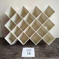 Front view of white Copco honeycomb wall spice rack with 16 compartments arranged in a diamond pattern. Shows overall shape and size relative to auction card.
