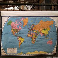 Full view of world map mounted on roller with colored political boundaries