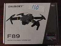 Front of box showing Chubory F89 micro foldable drone set with picture of drone and remote control with screen.
