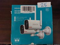 Front of the box showing two white Dekco security cameras with antennas on adjustable mounts, labeled as HD WiFi Security Cameras.