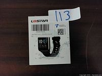 Front view of L8star Smart Watch retail box showing a black smartwatch with digital display.