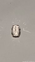 Front view of the light champagne colored cushion-cut morganite gemstone showing sparkle and facets.