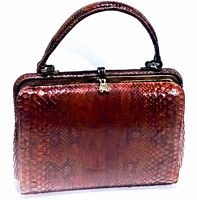 Front view of rectangular brown snakeskin handbag with metal clasp and top handle.