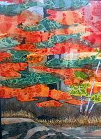 Close-up image showing the colorful watercolor painting with autumnal colors and tree motifs, framed under glass.