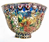 Side view of vintage Asian plique a jour bowl showing colorful floral and butterfly cloisonné enamel work on metal framework.