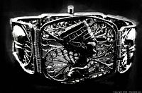 Close-up photo of vintage sterling silver Cleopatra bracelet showing the detailed filigree and Cleopatra profile design.