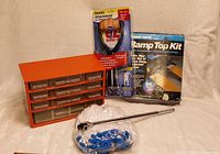 Photo showing all items: orange-red retro metal organizer with nine clear drawers, EZ Does handle attachment in packaging, bag of blue and white multi-use gloves, ramp top kit box.