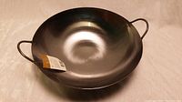 View of the new Magnum carbon steel wok showing interior and attached original tag