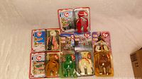 Photo showing unopened 1990s TY Beanie Babies in original McDonald's packaging arranged in two rows on a flat surface.