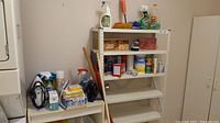 Full view of cleaning items on shelving unit and surface, shelving not included