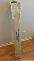 Tall cardboard box labeled Frank A Edmunds & Co, sealed with assembly instructions and suggestions taped on top.