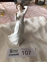 Front view of Royal Doulton figurine titled 'With Love' showing a woman in a flowing white dress holding a red rose near her face.