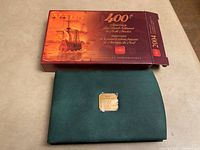 Closed decorative collector's outer box showing text commemorating the 400th anniversary of French settlement in North America, dated 2004.