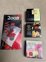 Five commemorative coins with their respective packaging: three floral 50 cent coins (Golden Tulip, Golden Daffodil, Golden Easter Lily), a sealed Polar Bear coin, and a maple leaf coin in 'Canada 2003' box.