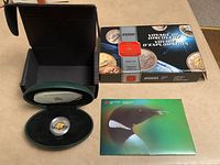 Boxed presentation case open showing Polar Bear $2 proof coin in protective capsule.