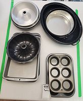 All baking items arranged: bundt pans, roasting dish, rectangles, muffin pans, springform pans