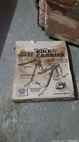 Top of the original packaging box for the Stow and Go Bike Carrier with instructions and item image visible.