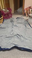 Photo of the deflated double air mattress spread on carpet, showing full length and width.