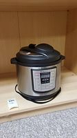 Front view of Instant Pot IP Lux80 pressure cooker showing digital control panel.