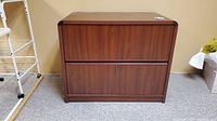 Front view of the wood veneer lateral filing cabinet showing two drawers and key lock.