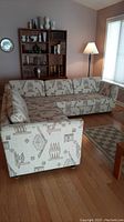 Front angle showing larger three-cushion section joined to smaller two-cushion section in living room