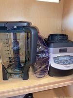 Photo of Ninja blender pitcher, control base, and Ziploc bag with blending cups.