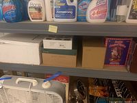 Shelf with boxes containing Christmas items like ornaments and decorations.
