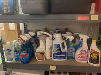 Shelf with assorted spray and liquid cleaning products including Windex, Bona, Clorox, Lysol, and Cerama Bryte.