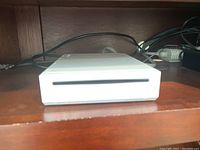 Front view of white Nintendo Wii console showing disc slot.