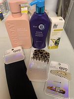 Photo showing the full set with hair care products and hair accessories arranged on a surface.