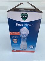 Photo of front of Vicks Sinus Inhaler box showing product and brand name. Packaging open at top.