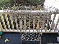 Full front view of both wire plant stands on porch