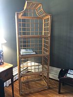 Full side front view showing entire bamboo shelving unit with 4 glass shelves and pagoda style top